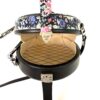 Bag open showing the beige quilted interior lining