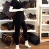 Mannequin holding the tote by the leather handles