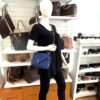 College bag worn crossbody on a mannequin in the boutique