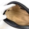 Interior opened by a gloved hand showing the tan lining