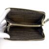 Interior opened by a gloved hand showing the card slots