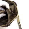 Gloved hand holding the wallet open by the zip pull