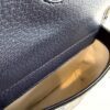 Close up of the navy leather flap and the cream lining