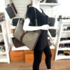 Rajah tote carried by a mannequin in the boutique