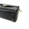 Angled view with the leather top handle raised