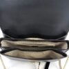 Interior held open showing the beige canvas lining