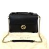 Bag shown resting on its original Gucci dust bag