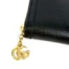 Close up of the gold double G charm on the zip pull