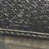 GUCCI blind embossed into the black calfskin above the seam