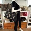 Mannequin holding the tote by its leather handles