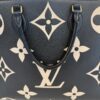 Close view of the beige giant monogram on black leather