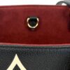 Interior D ring and strap against the suede