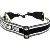 Strap coiled to show the CHRISTIAN DIOR embroidered lettering