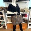 Tote shown on a mannequin from the caramel side
