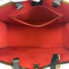 Interior zip pocket held open inside the tote