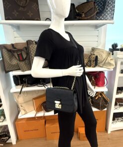 Marceau bag worn on the shoulder by a mannequin in the boutique