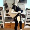 Mannequin holding the tote with the pouch