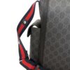 Rear three quarter with the strap raised for carrying