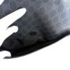 Gloved hand smoothing the GG Supreme canvas on the flap