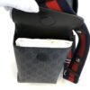 Gloved hand opening the flap to show the inner compartment