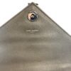 Underside of the flap with the snap and the Saint Laurent stamp