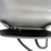 Flap opened to show the interior zip pocket and grey leather