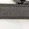 Close up of the chain strap and its grey leather shoulder pad