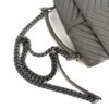 Angled view with the chain coiled in front of the bag