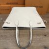 Top of the tote with the handles standing