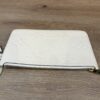 Pouch laid flat showing the gold zip