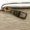 Zip pull embossed LOUIS VUITTON on the pouch