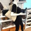 Soho tote carried on the shoulder by a mannequin in the boutique