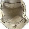 Interior opened showing the beige lining and zip pocket