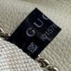 Black Gucci care tag stitched inside the bag
