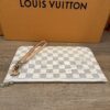 Pochette laid flat with the wristlet strap along the top