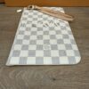 Overhead view of the pochette with the strap raised