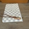 Three quarter view with the wristlet strap coiled