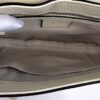 Interior held open showing the beige fabric lining