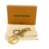 Louis Vuitton LV Circle bag charm and key holder in gold tone metal, shown with its box and dust bag