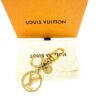 Charm laid on the dust bag in front of the orange box