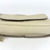 Side profile showing the slim depth and chain strap