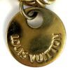 LOUIS VUITTON raised on the front of the round tag