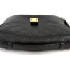Top of the bag laid flat with the strap beside it