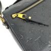 Angled view showing the zip and gold hardware