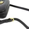 Strap detail with the gold clip and keeper