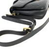 Adjustable strap coiled beside the bag