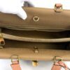 Interior opened by a gloved hand showing the zip pocket