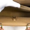 Interior compartment shown by a gloved hand with the clasp