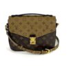 Louis Vuitton Pochette Metis in Reverse Monogram canvas with gold S-lock and adjustable strap