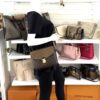 Mannequin wearing the bag with the strap across the back